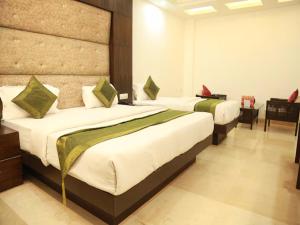 a bedroom with two beds and a desk at Hotel City Height - 2 Min from New Delhi Railway Station in New Delhi +12 photos