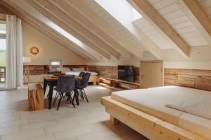 a bedroom with a large bed and a table and chairs at Ferienwohnungen Gut Mischenried in Weßling