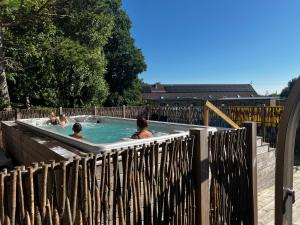 a group of people swimming in a hot tub at Mobil home neuf à étaples à 5 minutes du touquet in Étaples