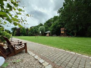 a park with a playground with a bench at Koło Żółwia in Gąski