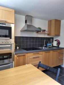a kitchen with wooden cabinets and a stove top oven at Beachfront apartment in Åhus in Åhus