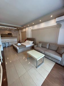 a living room with a couch and a bed at Stefanidis Platani Beach in Stavros