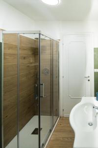 a bathroom with a glass shower and a sink at Residenza IL COLLE in Subiaco