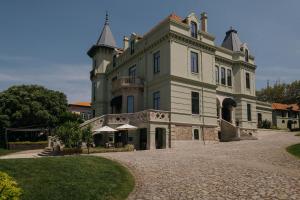 a large building with a tower on top of it at Vila Foz Hotel & SPA - member of Design Hotels in Porto