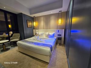 a hotel room with a bed and a desk at Floric Hotel in Jāmb
