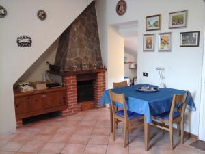 a dining room with a table and a fireplace at Villino Arcola in Arcola