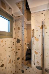a bathroom with a rock climbing wall at Mediterranean Blue Suites & Villa - Blue Bay Suite in Tympáki