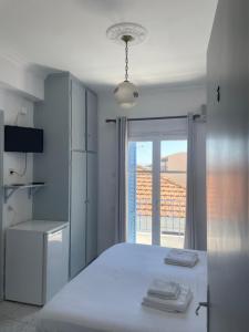 A bed or beds in a room at Agnàntema Portside Stays Skiathos