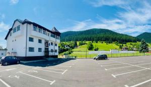 a parking lot in front of a building at Vila Stadion in Câmpulung Moldovenesc