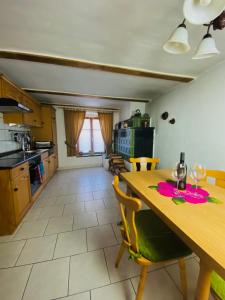 a kitchen and dining room with a wooden table and chairs at Ferienwohnung der Familie Budzisch in Sinsheim