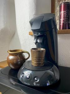 a coffee maker with a cup on top of a counter at Ferienwohnung der Familie Budzisch in Sinsheim +19 photos