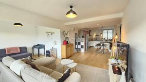 a living room and kitchen with a couch and a table at Le Therme #Garage#Balcon - Meublé classé 3étoiles in Chamalières