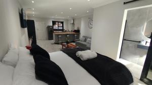 a bedroom with a large bed with black and white pillows at DINAS Self-Catering Accommodation Flat 2 in Oranjemund
