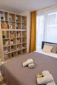 a bedroom with a bed with towels on it at Good Mood Apartments & Parking in Plovdiv
