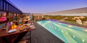 a hotel with a swimming pool on a building at Regenta Central Javaji Mysore in Mysore