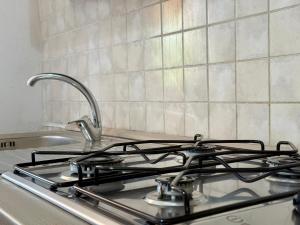 a stove top with a faucet in a kitchen at Casa Bellini - Cava D'Aliga in Cava dʼAliga