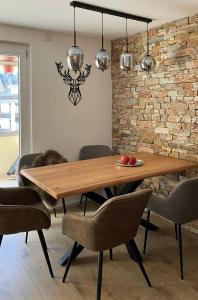 a dining room with a wooden table and chairs at Spacious 3 Room Apartment - Family-Friendly - Central Leukerbad - Great Views in Leukerbad