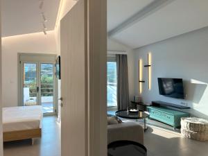 a living room with a couch and a tv at Aura Suites in Leipsoi