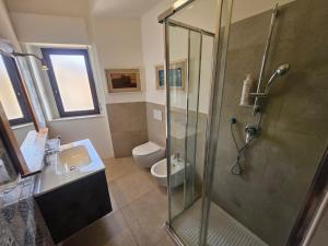 a bathroom with a shower and a sink and a toilet at Zafferana Etna House by Holiday World in Zafferana Etnea