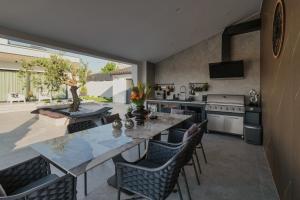 a kitchen and dining room with a table and chairs at Villa KIM in Momjan