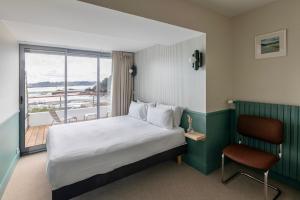 a hotel room with a bed and a balcony at Hôtel BelleVue in Bréhat +46 photos