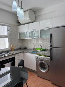 a kitchen with a washer and a dishwasher at Résidence BAB Sebta apartment Ghali in Fnidek