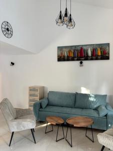 Una sala de estar con un sofá azul y una mesa. en Sea Garden House Mandre, en Mandre