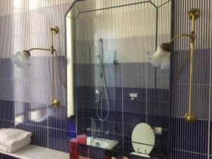 a bathroom with a shower and a toilet and a mirror at Relais Teatro Argentina in Rome +27 photos