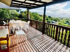 a wooden deck with a table and chairs on it at Sedgefield Vacation Home in Sedgefield