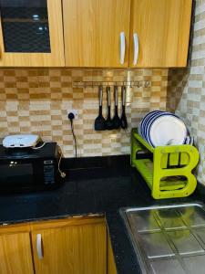 a kitchen counter with a plate rack and a sink at Executive 4 Bedroom Bungalow at New Haven Extension, Enugu in Enugu