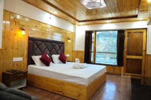 a bedroom with a bed with a stuffed animal on it at Sparkle Heights in Mussoorie