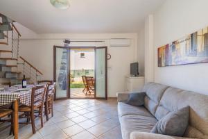 a living room with a couch and a table at Casa del Sole in Budoni