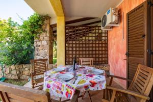 a table with plates on it on a patio at Casa del Sole in Budoni