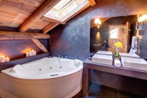 a bathroom with a large tub and two sinks at Chalet de Claude in Morzine - by EMERALD STAY in Morzine