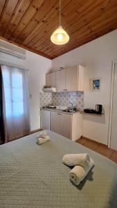 a kitchen with a large bed with towels on it at Armonia Guesthouse in Panormos Skopelos +43 photos