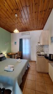 a kitchen and a bedroom with a bed and a table at Armonia Guesthouse in Panormos Skopelos