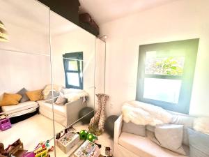 a living room with a mirror and a couch at Luxury 6 bedroom 4 bathroom villa with pool in Vari