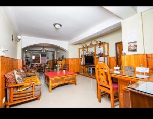a living room with a couch and a table at sunset nest Drokpas rest heart of Darjeeling in Darjeeling
