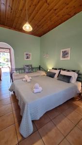 a bedroom with a large bed with towels on it at Armonia Guesthouse in Panormos Skopelos