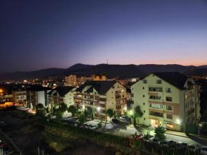 a view of a city at night with buildings at Jazz Residence 2 in Piatra Neamţ