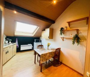 a kitchen with a table and chairs and a window at Appartement rustique à Liège in Liège