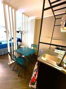 a room with a table and a sink and a bed at Studio LEIRIA Side in Leiria