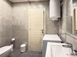a bathroom with a sink and a toilet and a mirror at Skadarlija Soul in Želenička Stanica Beograd Sava