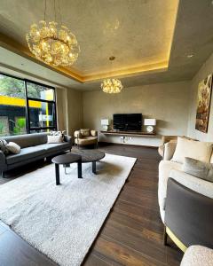a living room with a couch and a table at Pretty haven-studio apartment -Kilimani in Nairobi
