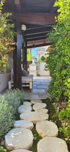 a garden with stepping stones and a pergola at Villa Maria in Trani