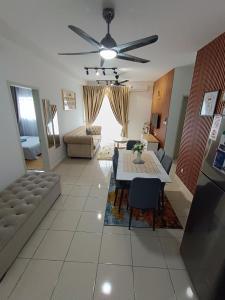 a living room with a table and a couch at FA Homestay Alanis, Near KLIA in Sepang