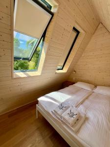 a bed in a room with a window at Jelenie Brdy in Brzegi Dolne