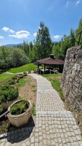 a stone pathway with a picnic table in a park at Hotel Karolinka in Karpacz