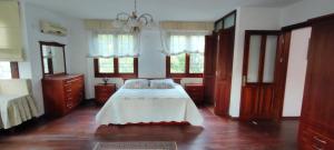 a bedroom with a large bed with wooden floors and windows at Kuşadası'nda Özel Havuzlu Kiralık Büyük Villa in Kusadası +75 photos