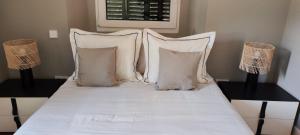 a bed with white pillows and two lamps on it at La Casita de Christian in Madrid +17 photos